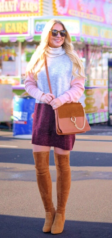 Women's black framed sunglasses, gray and pink long sleeve mini dress, brown knee high suede boots and brown leather crossbody bag outfit.