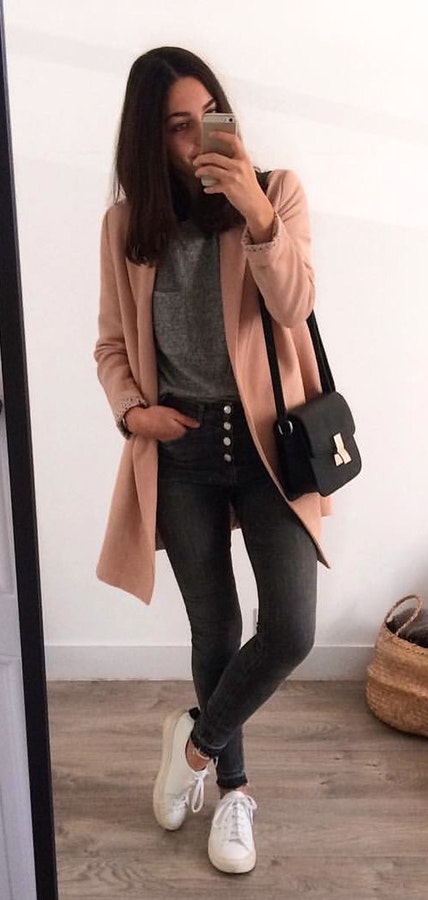 Women's brown cardigan, gray shirt, black denim jeans and pair of white low-top sneakers.