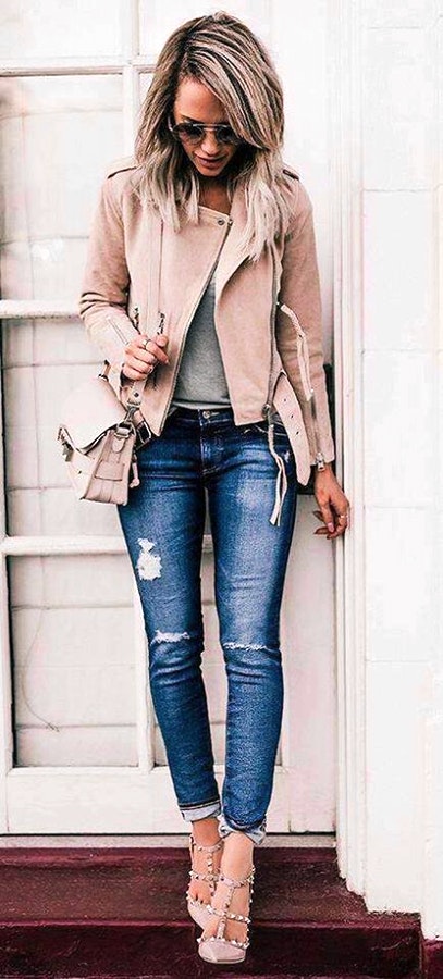 Women's brown rider's jacket with blue denim jeans outfit.