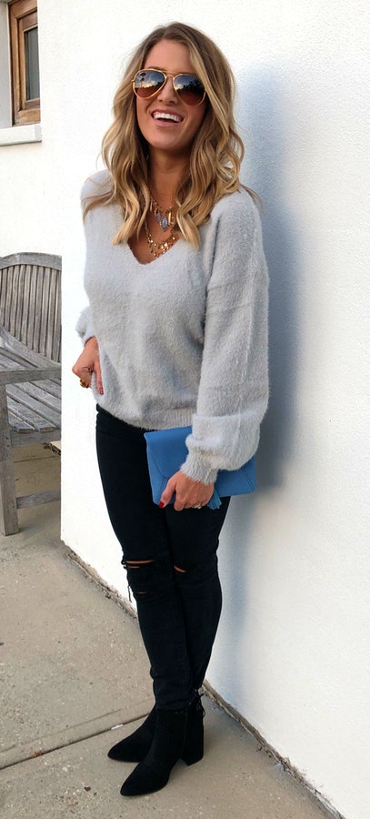 Women's gray suede scoop neck long-sleeved shirt and black skinny jeans.