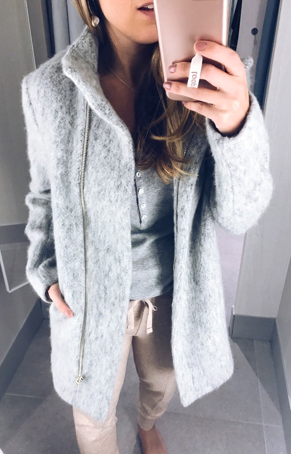 Women's gray zip-up coat.