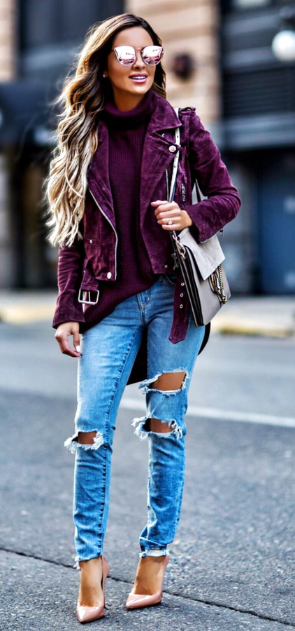 Women's purple zip-up jacket and distressed blue jeans.